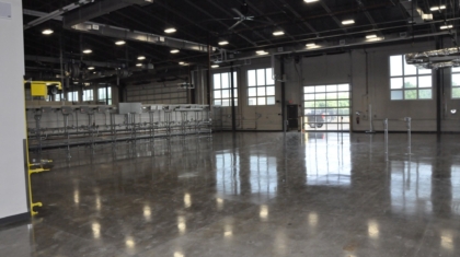 A large warehouse-like interior with a polished concrete floor at GCCC