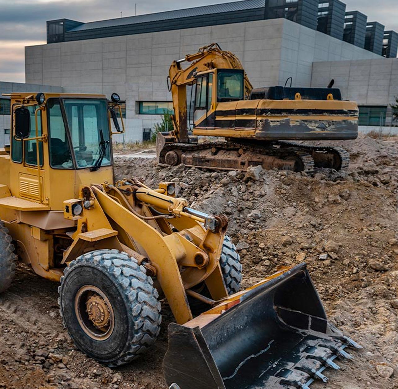 A bulldozer parked in front of construction manager at risk project
