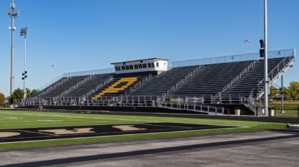 A football field with bleachers and pressbox by Miller Diversified