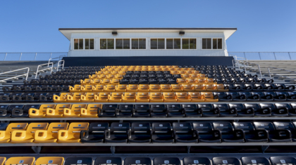 A row of yellow and black bleachers from a bleacher construction project by Miller Diversified